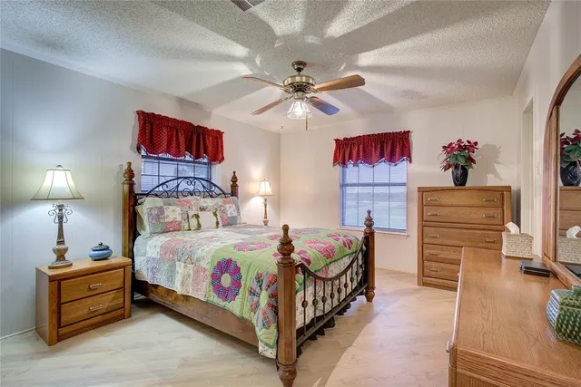 a bedroom with bed and cabinets