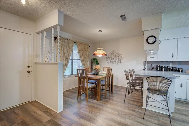 a view of a dining room with furniture and wooden floor