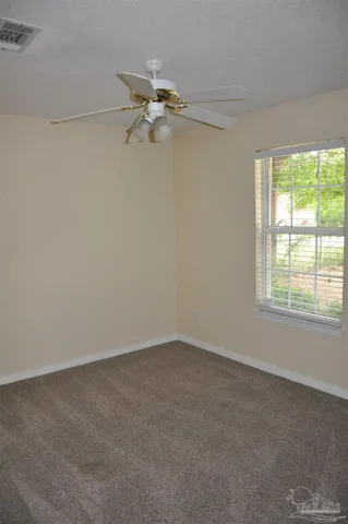 a small space with a window and a fan