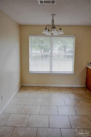 a view of kitchen with stainless steel appliances granite countertop a sink and cabinets