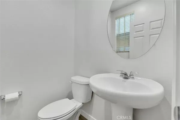 a bathroom with a sink a mirror and a toilet