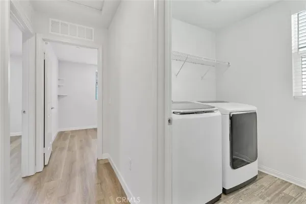 a view of walk in closet with empty racks