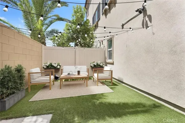 a view of a patio with table and chairs with plants