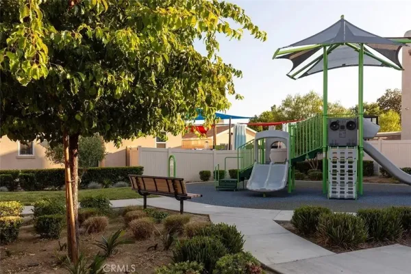 a childrens park with lots of swings slides and swimming pool