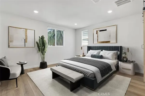 a bedroom with a large bed and a couch