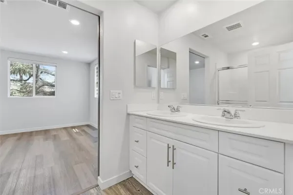 a bathroom with a double vanity sink and a mirror