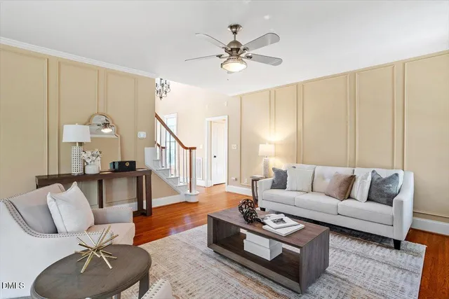 a living room with furniture and a potted plant