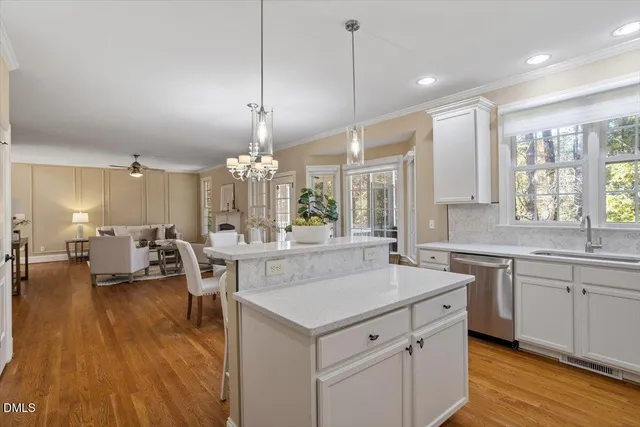a large white kitchen with a large island