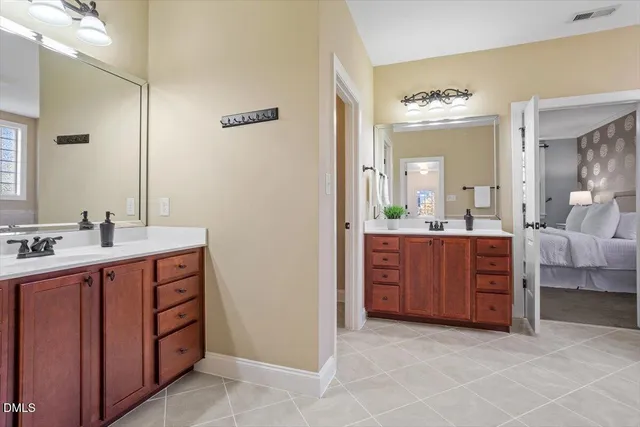 a spacious bathroom with a double vanity sink and a mirror