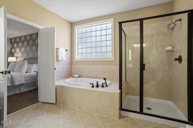a bathroom with a tub shower and sink
