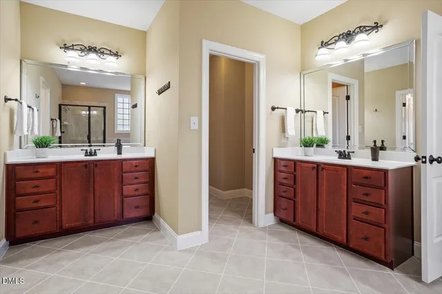 a spacious bathroom with a granite countertop sink and a mirror