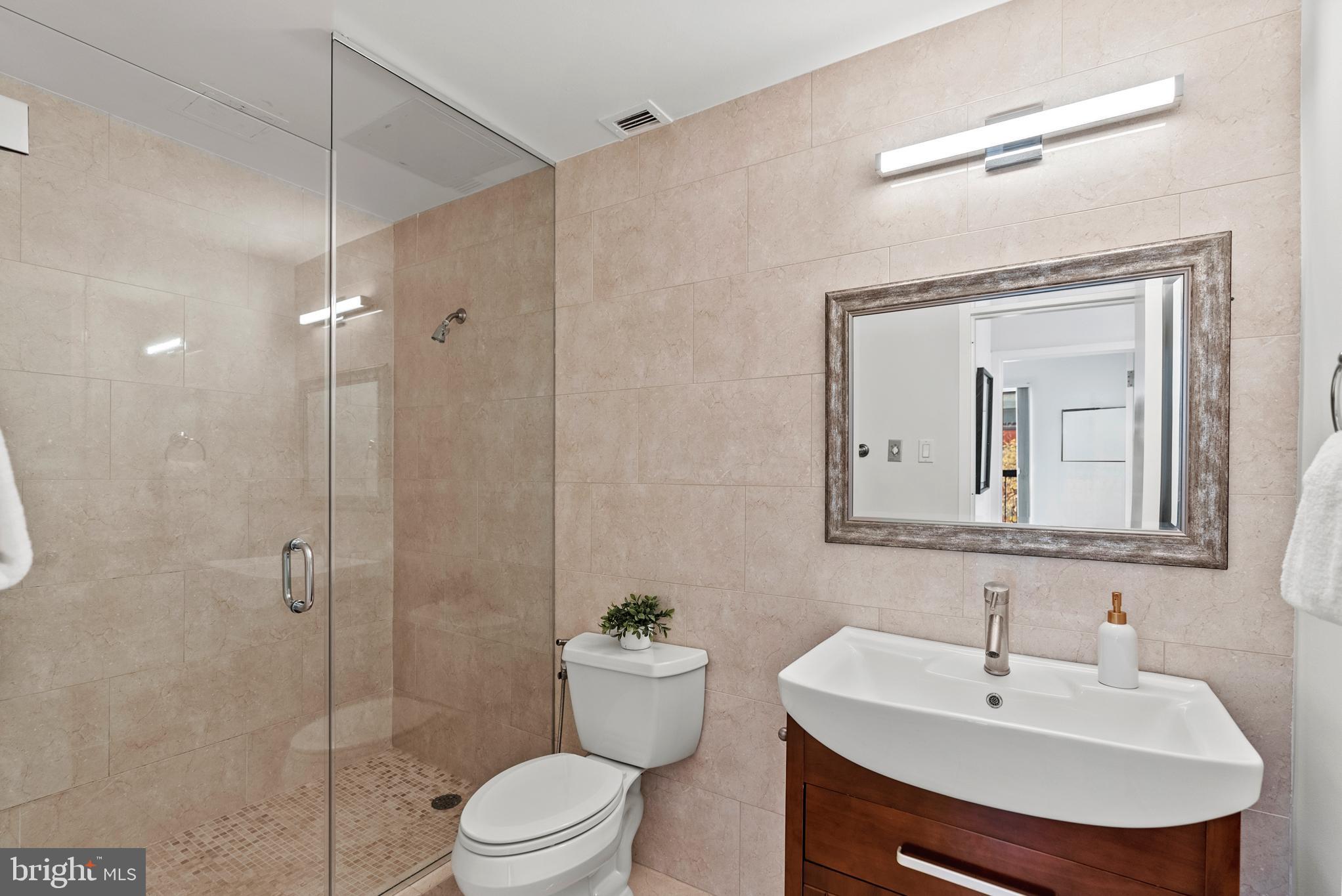 3251 Prospect Street Northwest, Unit 319 Washington, DC 20007 - Photo 11 of 16 a bathroom with a toilet sink and shower