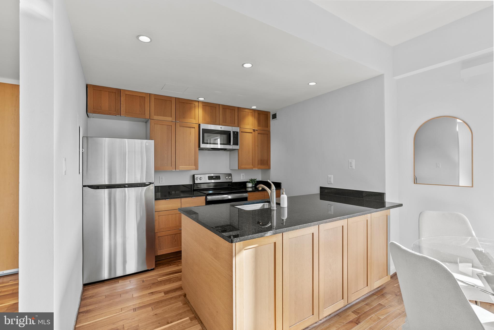 3251 Prospect Street Northwest, Unit 319 Washington, DC 20007 - Photo 7 of 16 a kitchen that has a sink and a refrigerator