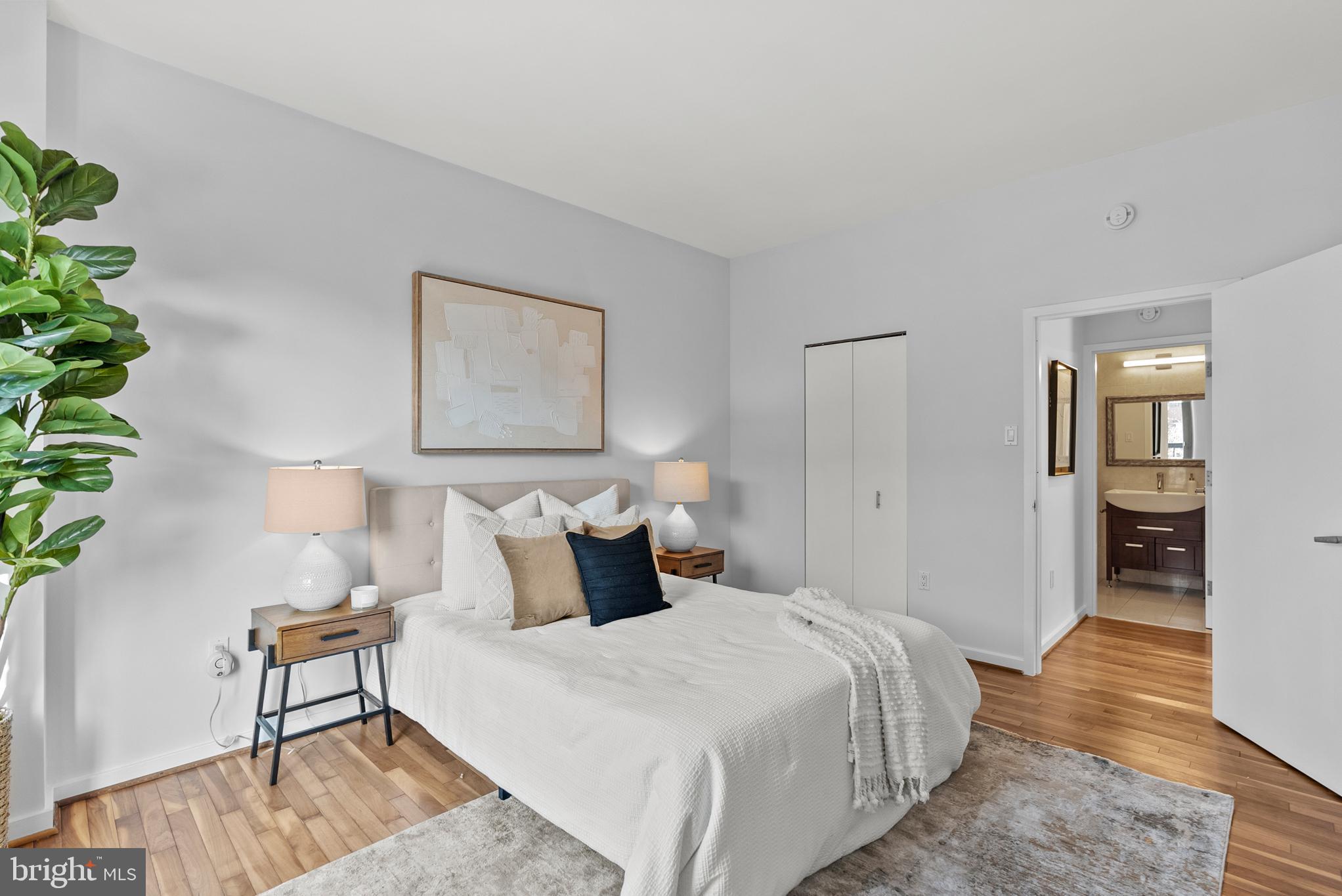 3251 Prospect Street Northwest, Unit 319 Washington, DC 20007 - Photo 10 of 16 a bedroom with bed and wooden floor