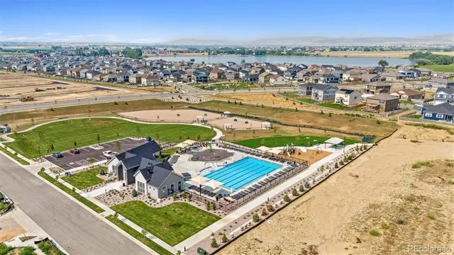 swimming pool view with a lake view