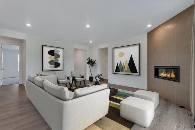 a living room with furniture and a painting on the wall