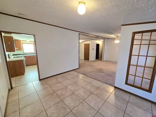 a view of a hallway to rooms and wooden floor