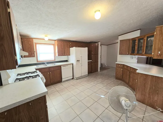 a kitchen with stainless steel appliances a refrigerator sink and cabinets