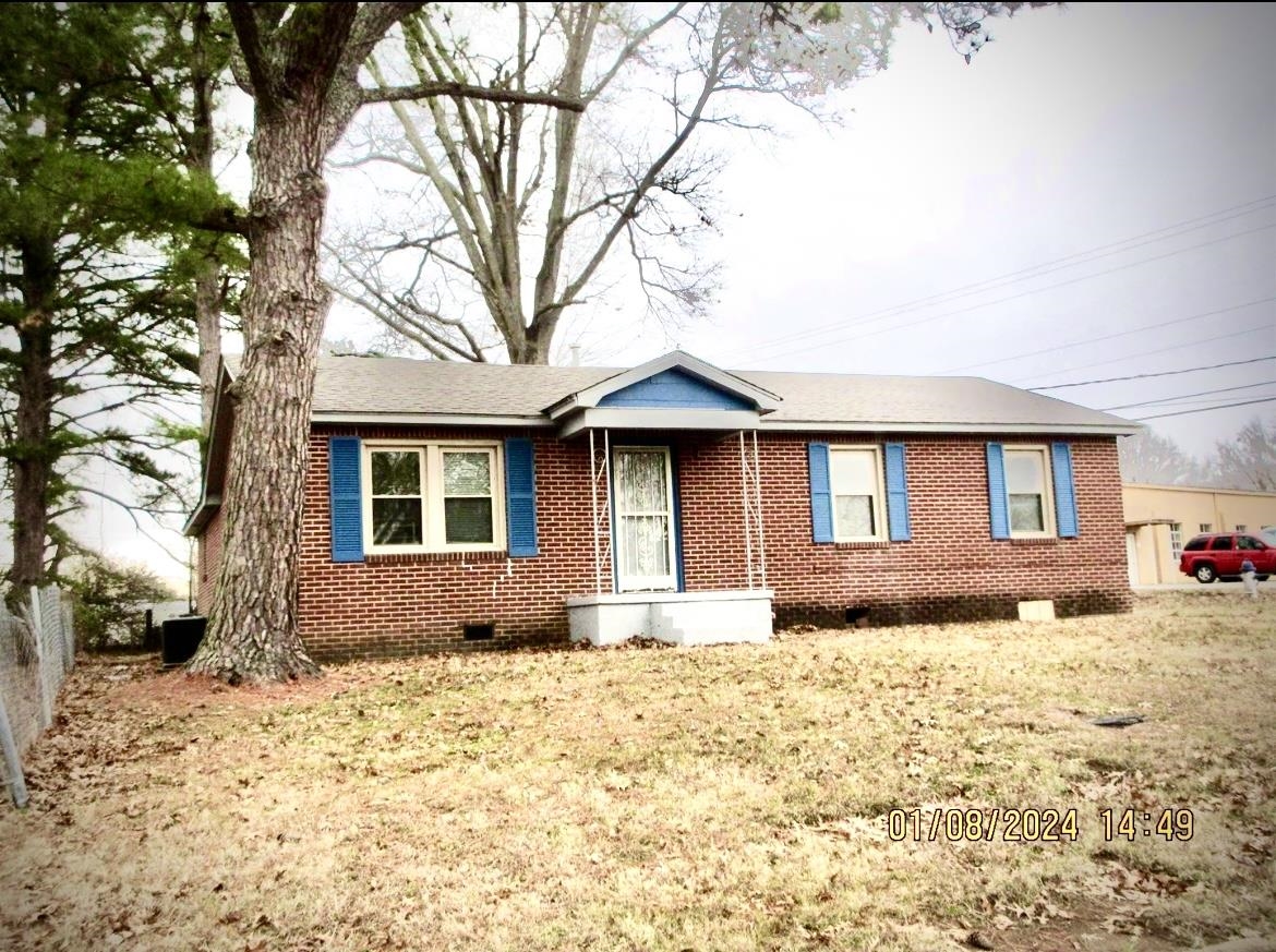 493 Perkins Street Ripley, TN 38063 - Photo 1 of 12 a front view of a house with a yard covered in snow