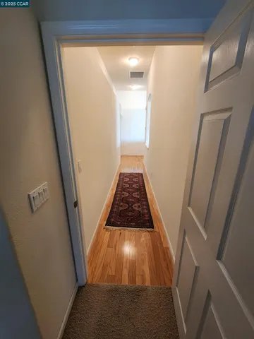 a front view of a house with a yard and tree