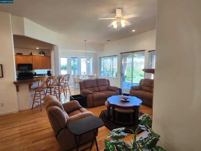 a living room with furniture a chandelier and a flat screen tv