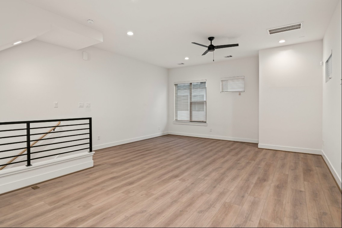 816 Curtin Street, Unit D Houston, TX 77018 - Photo 22 of 30 wooden floor in an empty room with a window