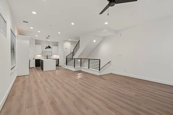 a view of kitchen and hall with wooden floor