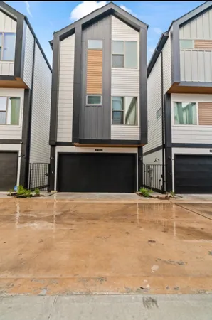 a front view of a house with a road