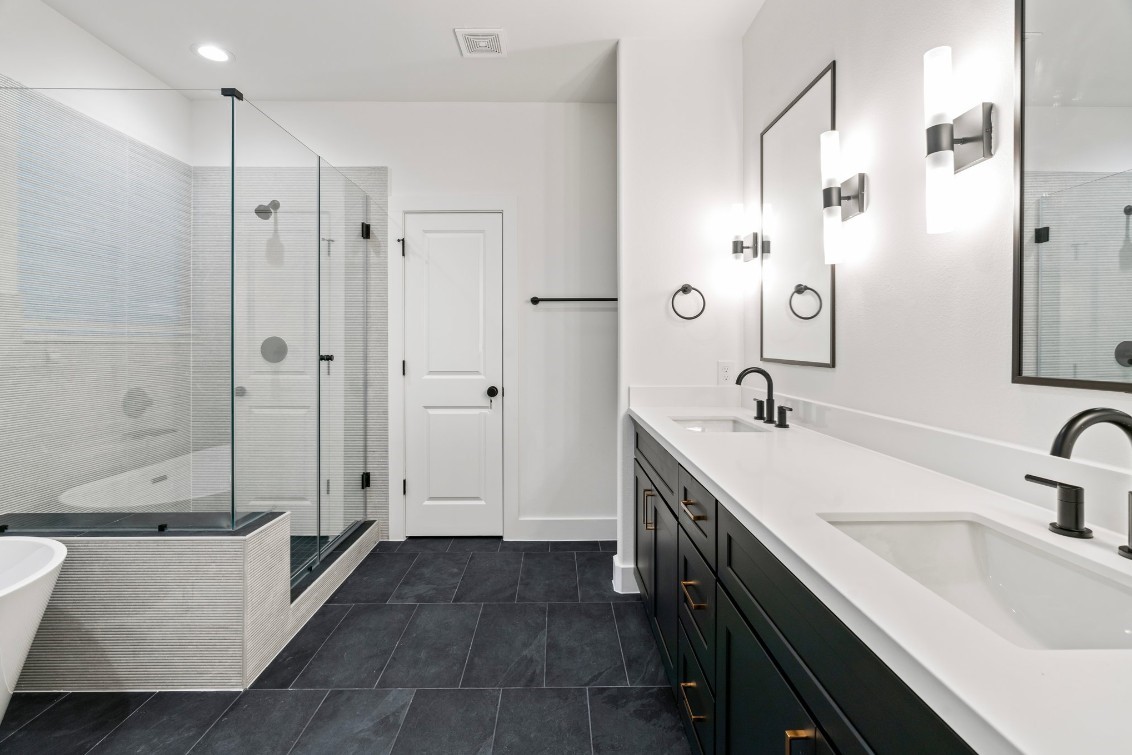 816 Curtin Street, Unit D Houston, TX 77018 - Photo 3 of 30 a bathroom with a double vanity sink a toilet and shower