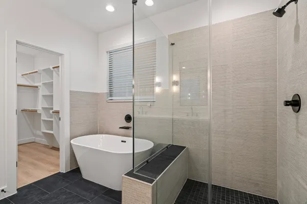 a bathroom with a bathtub and shower