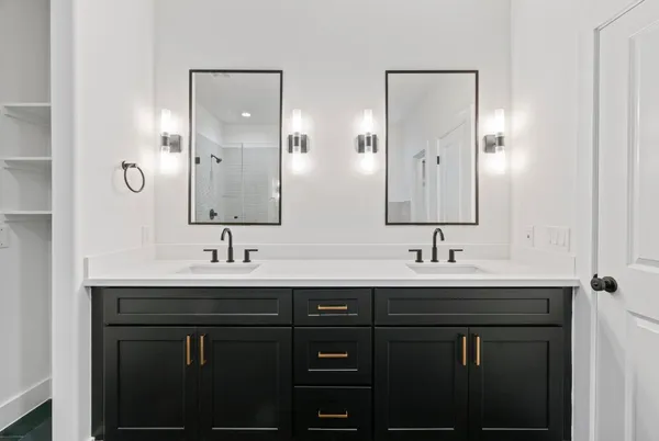 a bathroom with double sink and a mirror