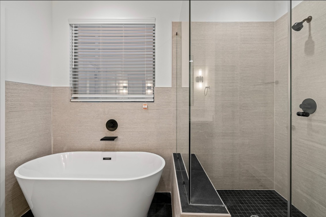 816 Curtin Street, Unit D Houston, TX 77018 - Photo 9 of 30 a white bath tub sitting in a bathroom
