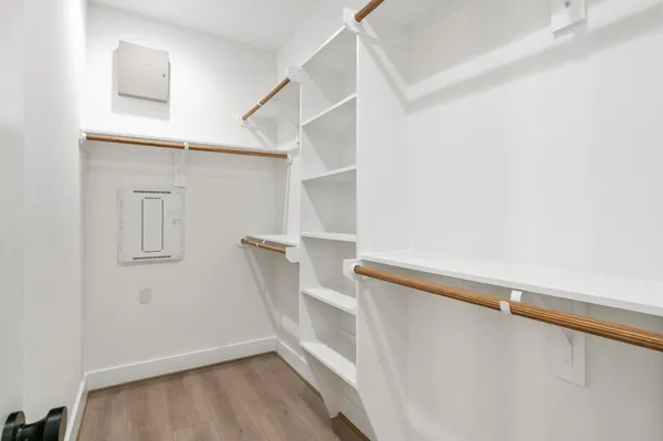 a view of walk in closet with empty racks