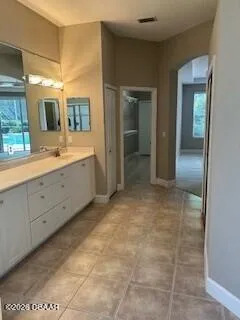 a view of a bathroom with sink mirror and window