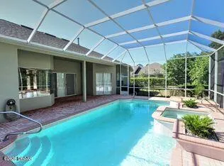 a view of a house with backyard sitting area and garden