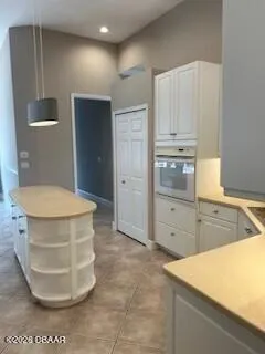 a view of a kitchen with kitchen island a sink a stove and a refrigerator