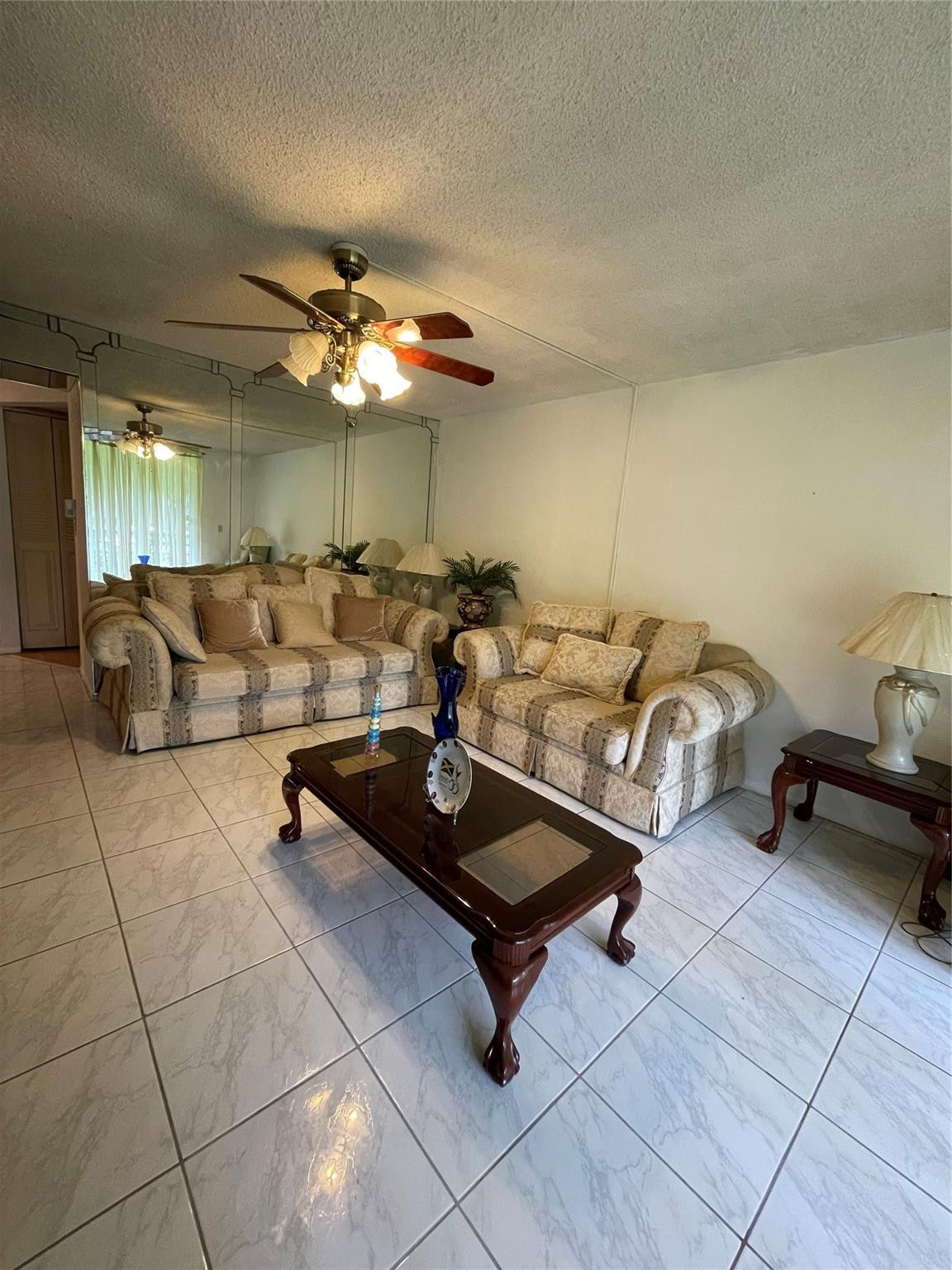 3490 Foxcroft Road, Unit B101 Miramar, FL 33025 - Photo 1 of 10 a living room with furniture a ceiling fan and a rug