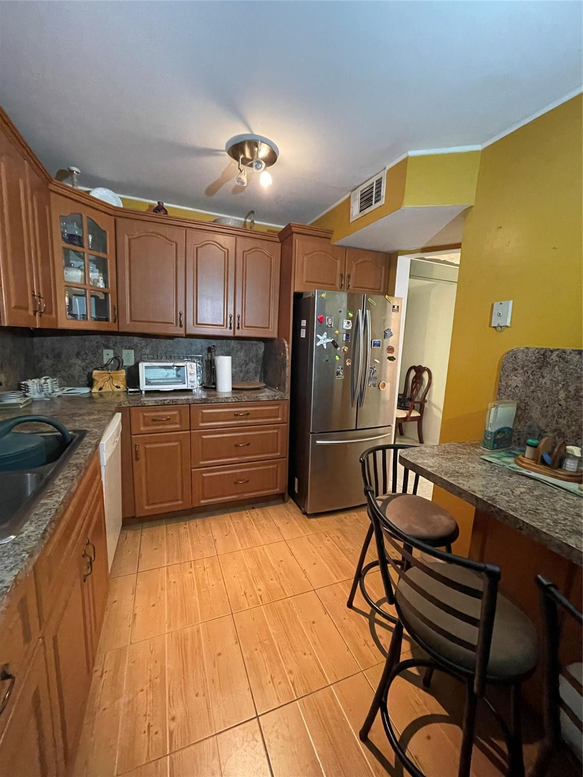 3490 Foxcroft Road, Unit B101 Miramar, FL 33025 - Photo 4 of 10 a kitchen with granite countertop a sink cabinets and stainless steel appliances