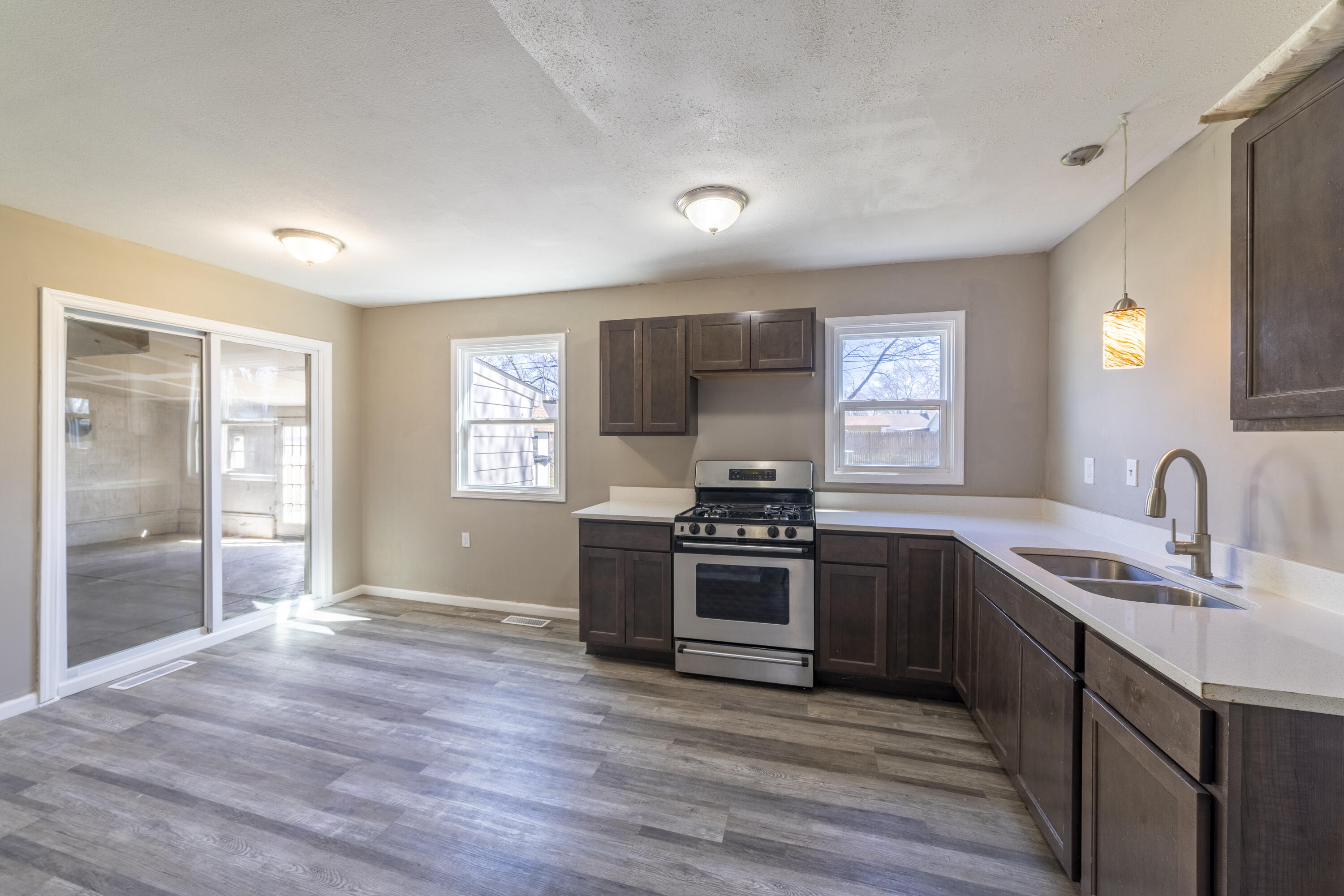 765 Governor Road Valparaiso, IN 46385 - Photo 6 of 26 a kitchen with granite countertop a stove top oven and sink