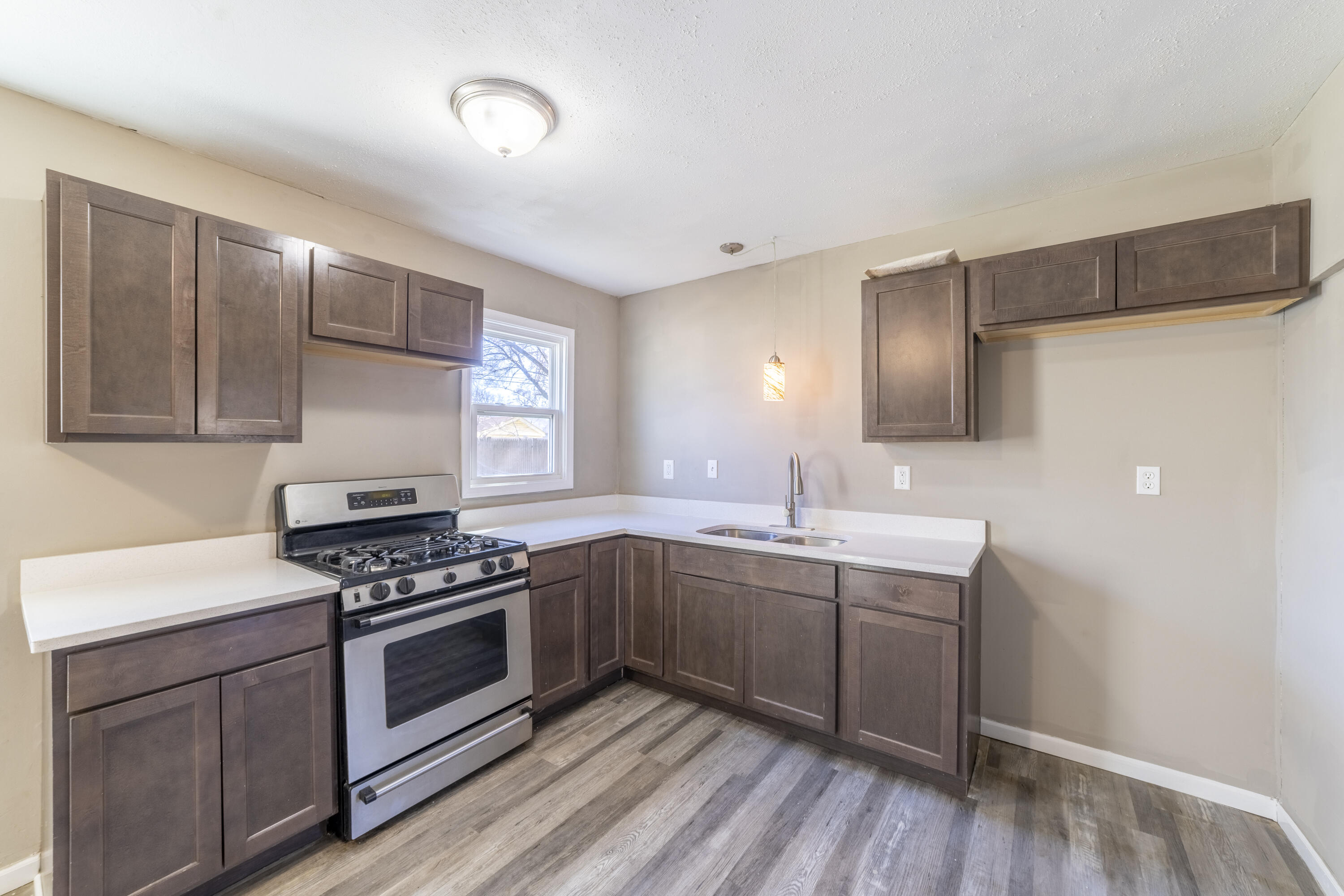 765 Governor Road Valparaiso, IN 46385 - Photo 7 of 26 a kitchen with stainless steel appliances a sink cabinets and wooden floor