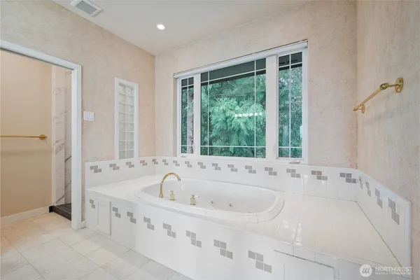 a bathroom with bathtub with window