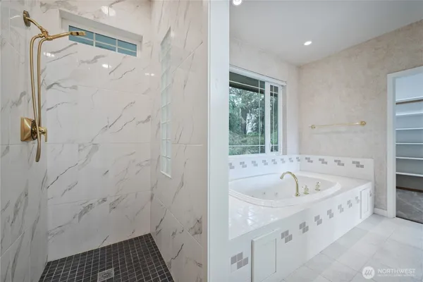 a bathroom with a bathtub and a shower