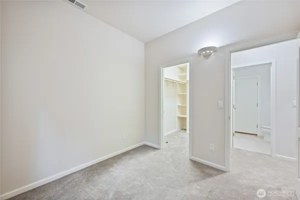 a bathroom with a granite countertop toilet a sink and a mirror