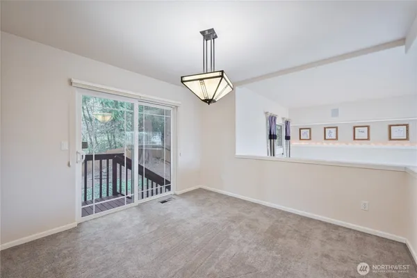 a view interior of a house with wooden floor windows and a ceiling fan
