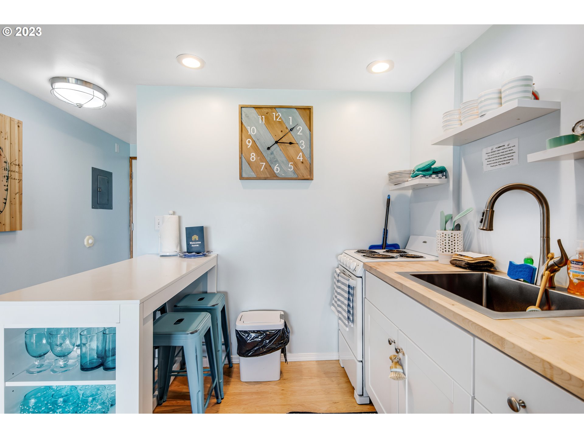 2316 Beach Drive, Unit 157 Seaside, OR 97138 - Photo 11 of 24 a kitchen with a sink and a stove with wooden floor