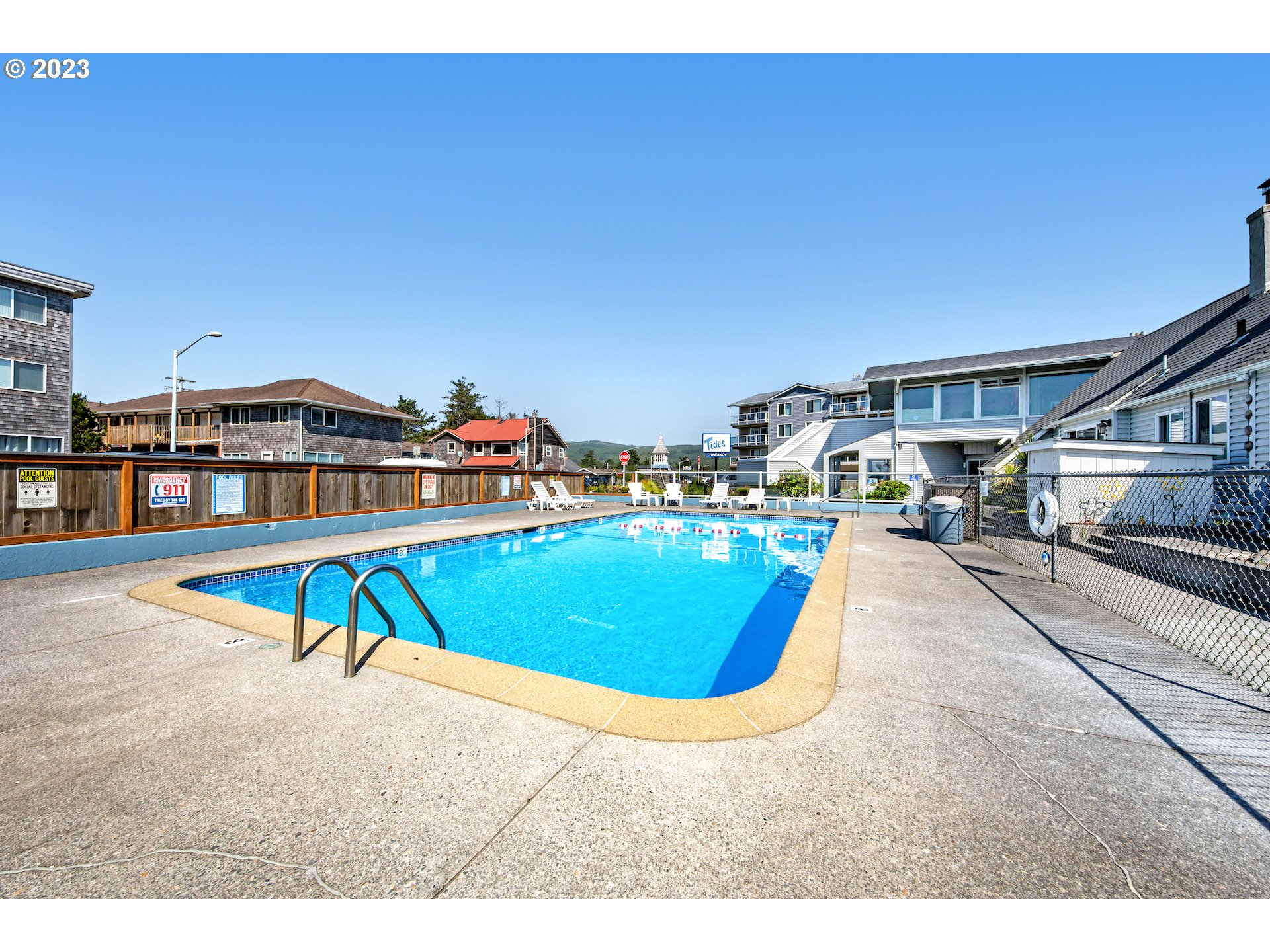 2316 Beach Drive, Unit 157 Seaside, OR 97138 - Photo 13 of 24 a swimming pool with outdoor seating and city view