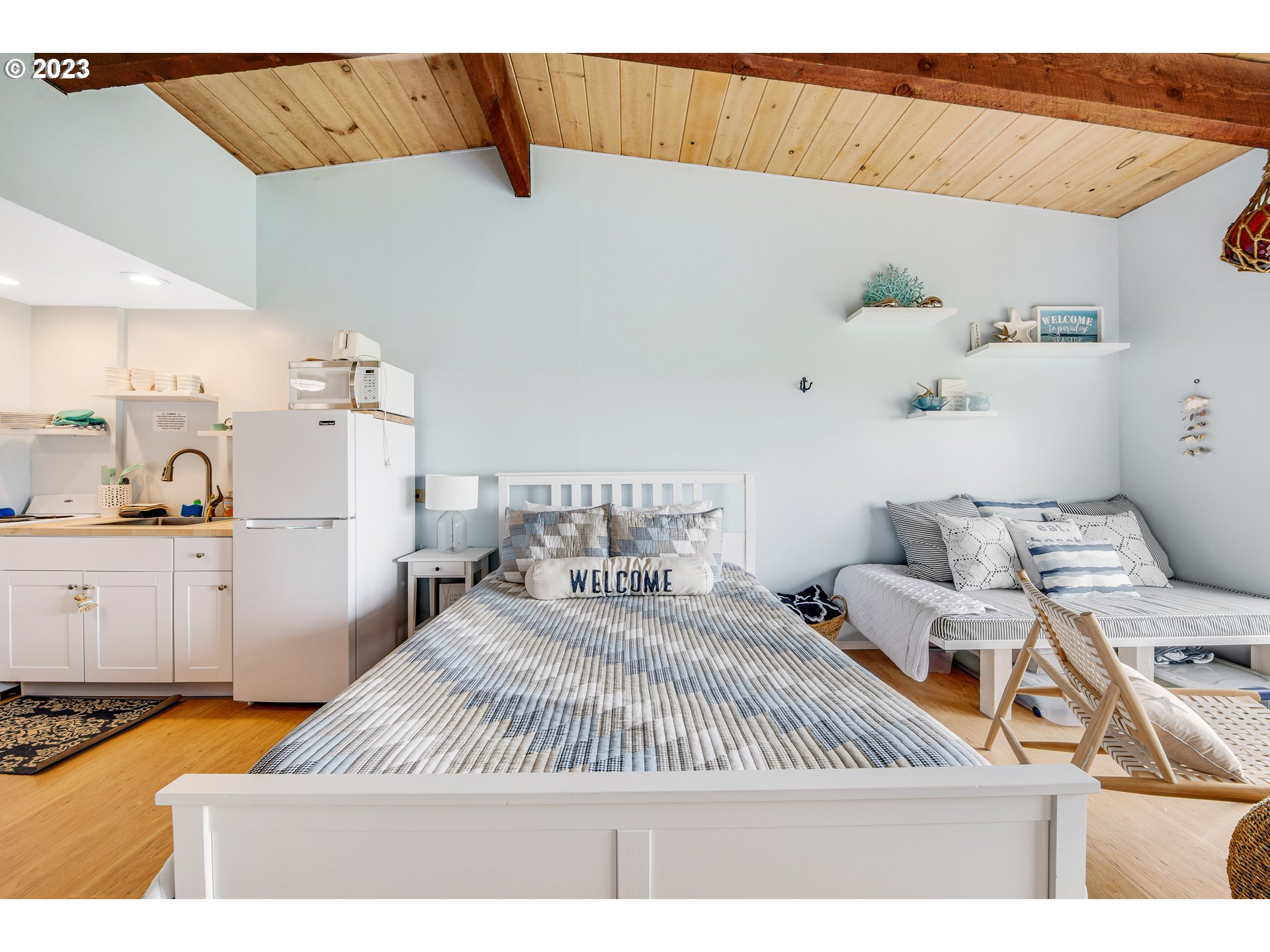 2316 Beach Drive, Unit 157 Seaside, OR 97138 - Photo 9 of 24 a bedroom with a bed and wooden floor