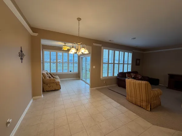 a spacious bedroom with a bed and a large window