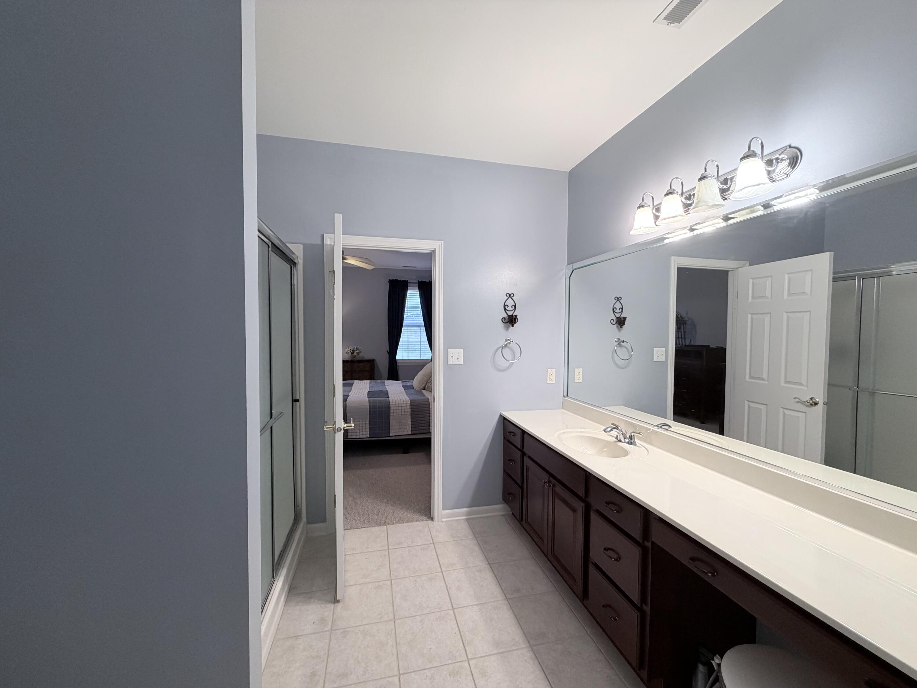 11677 Maryland Street Crown Point, IN 46307 - Photo 16 of 31 a spacious bathroom with a double vanity sink and a mirror