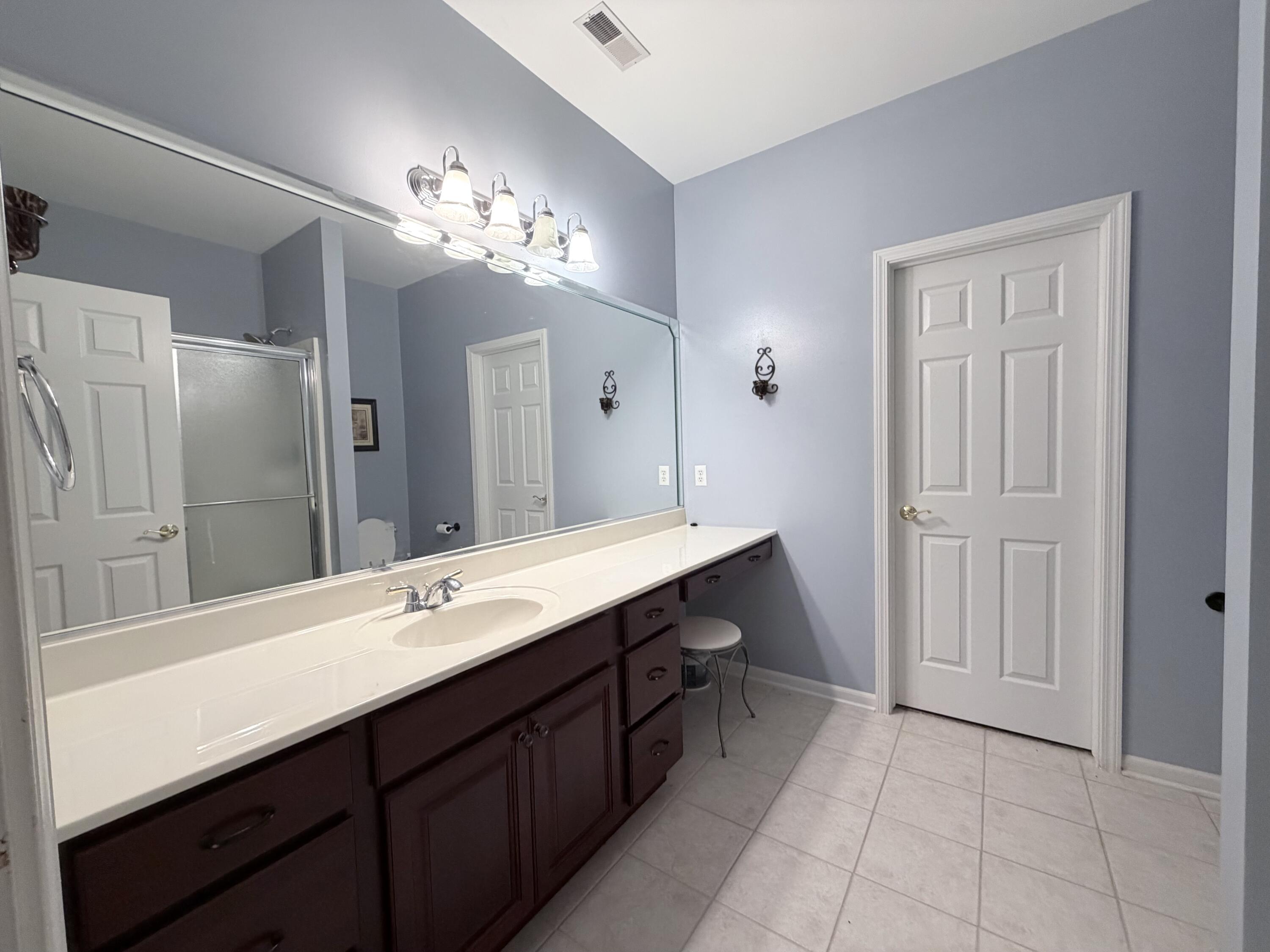 11677 Maryland Street Crown Point, IN 46307 - Photo 17 of 31 a bathroom with a double vanity sink and a mirror